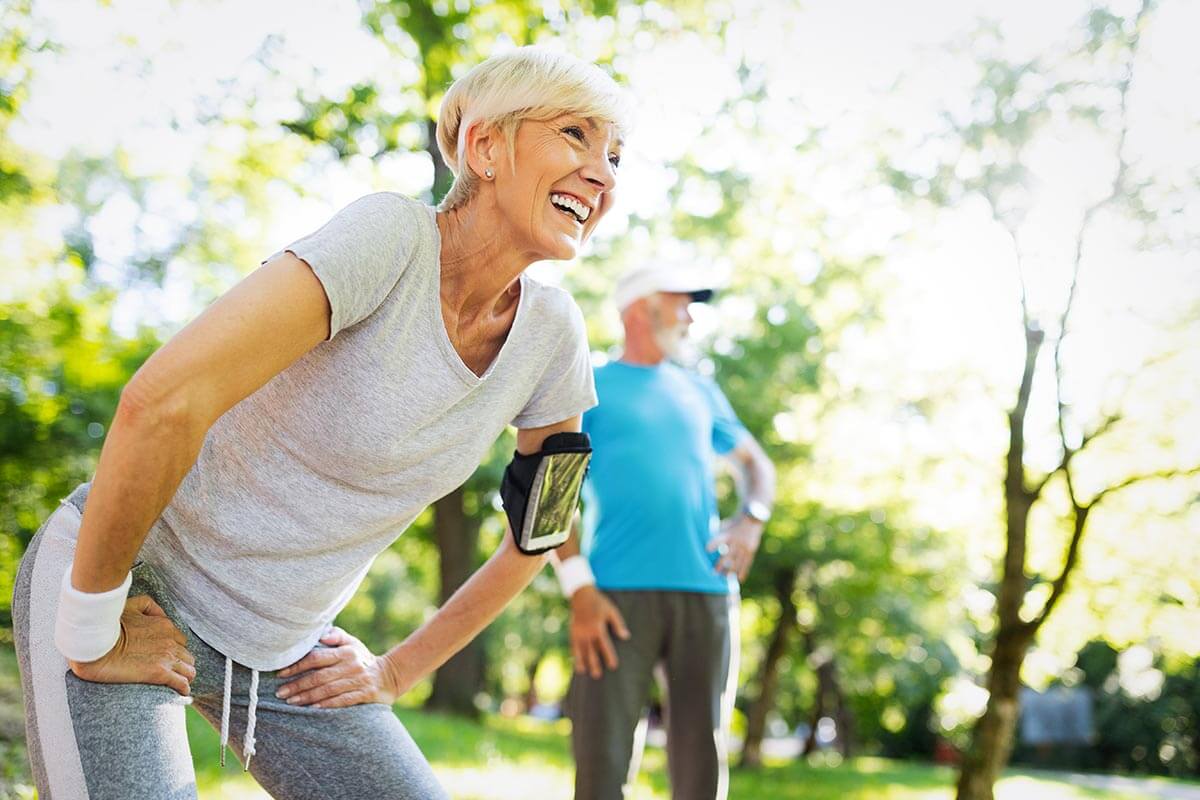 Active senior woman and man in a park